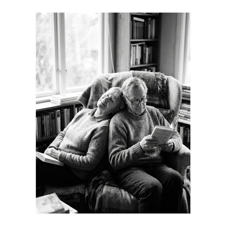 White Streamline frame, 17x22,  no mat, holding a photo of an older couple reading in an armchair 