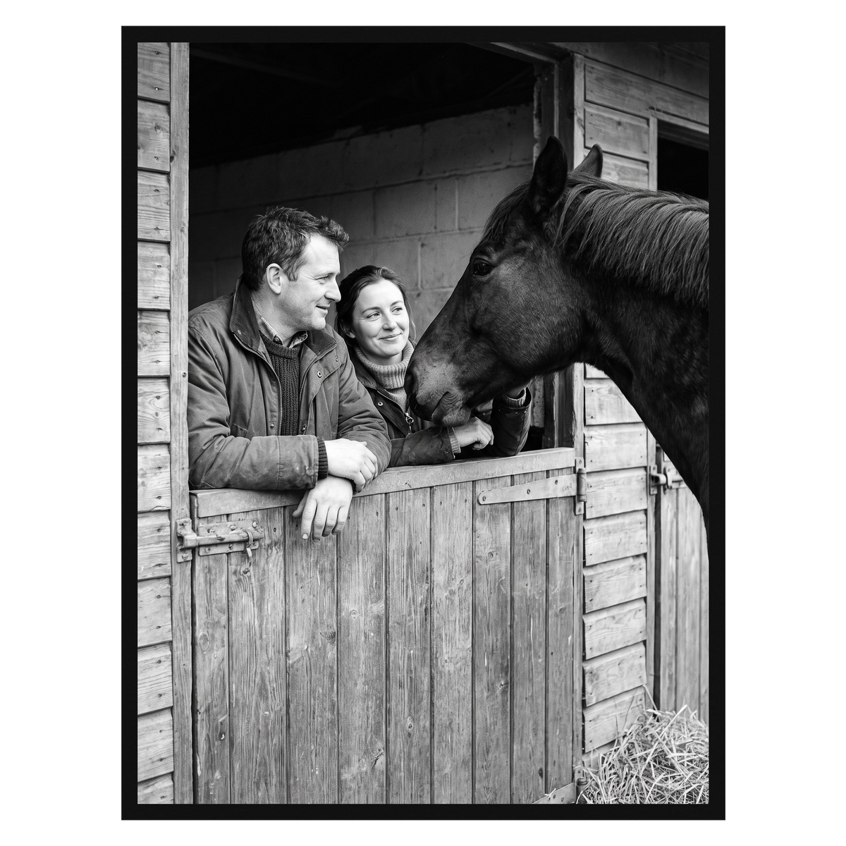 Black Streamline frame, 24x32,  no mat, holding a photo of a couple with a horse at a stable door 