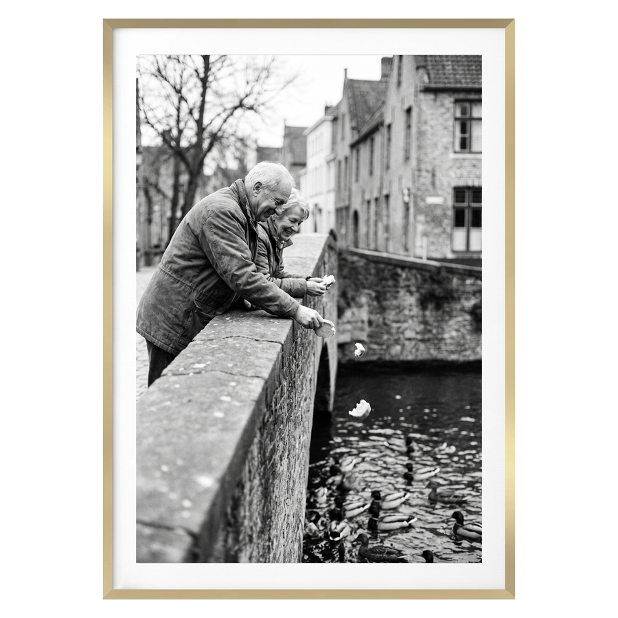 Gold Streamline frame, 28x40, with a 24x36 white mat, holding a photo of an older couple on a canal bridge 