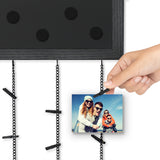 Close-up of the chalkboard header's magnets and a hand clipping on a photo 