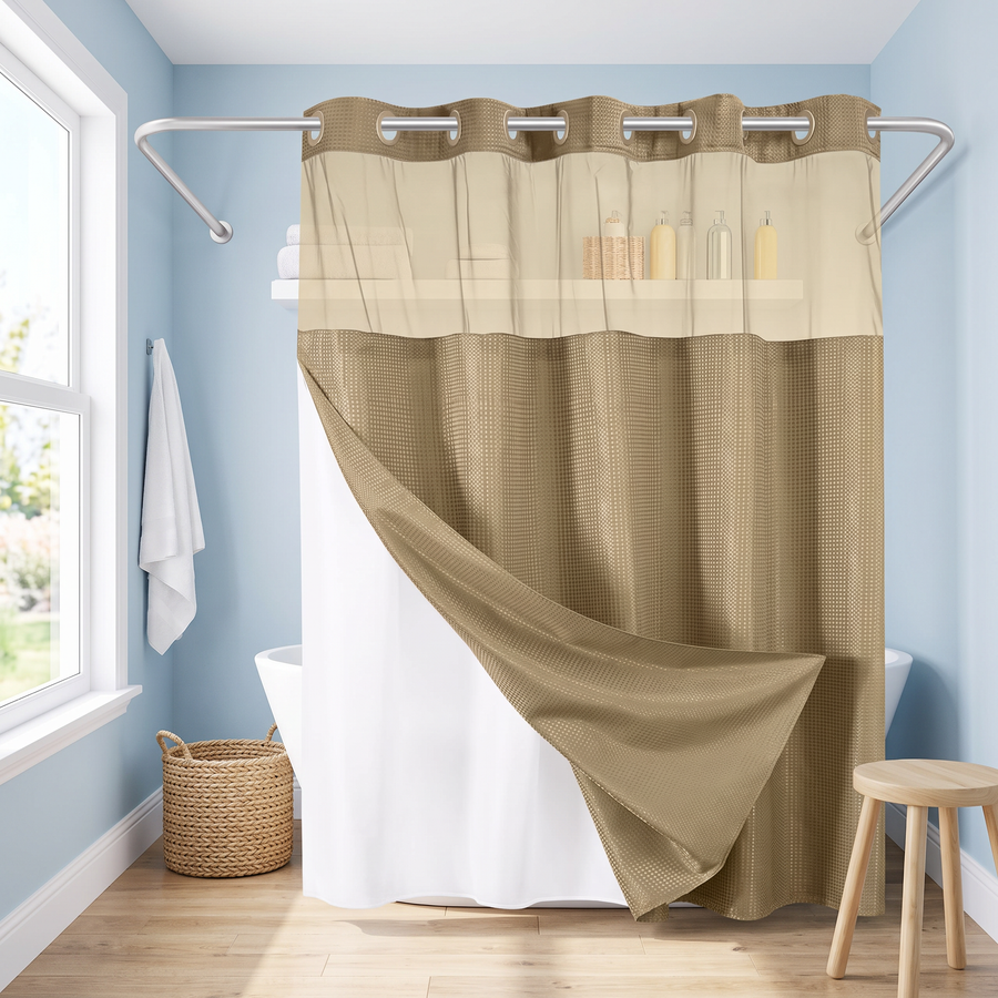 A two-tone shower curtain in a staged bathroom setting. The top section is a warm beige with a subtle waffle texture, and the bottom section is a solid taupe-brown. 