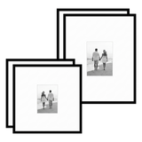 Pair of black Streamline frames with white mats, holding photos of a couple on a beach 