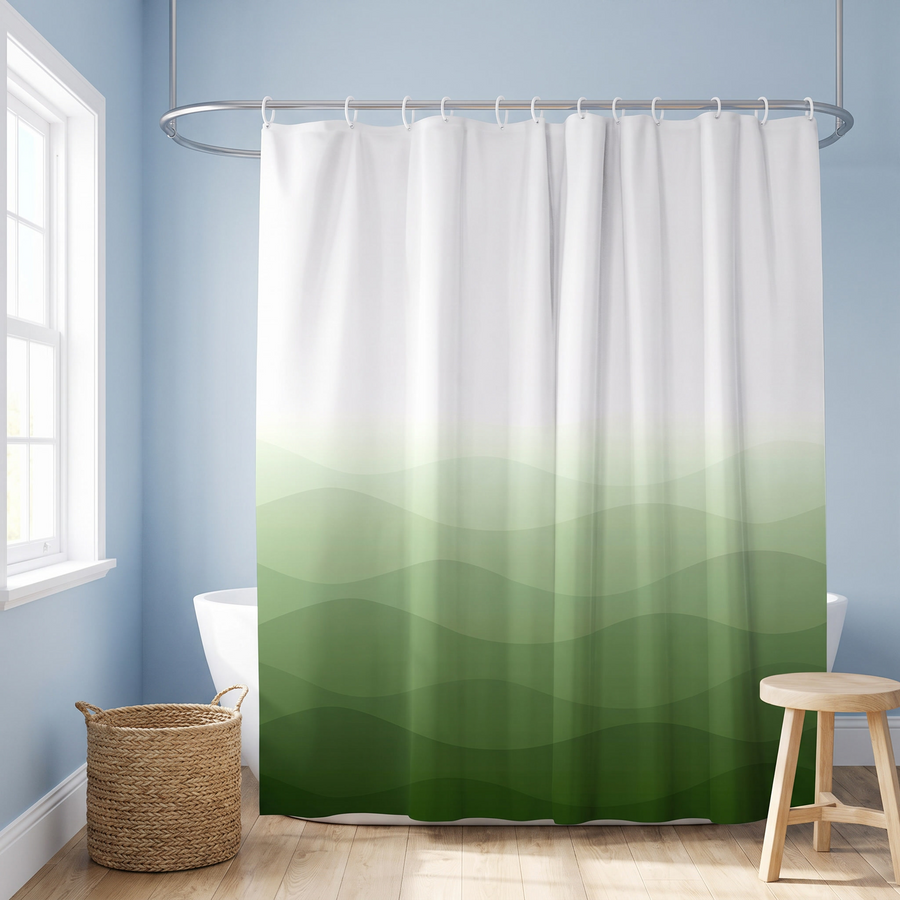A shower curtain with a white-to-green ombré wavy pattern hanging in a bright bathroom with light blue walls, a window, a woven basket, and a wooden stool. 