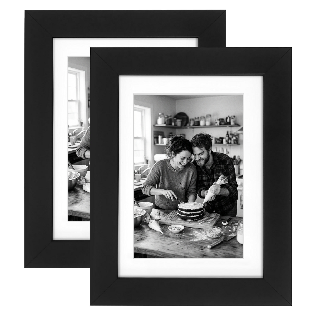 Two black Signature frames with white mats, holding a photo of a couple baking a cake 