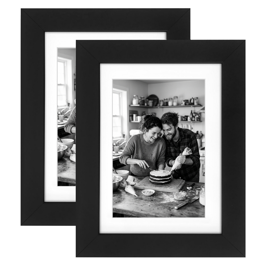 Two black Signature frames with white mats, holding a photo of a couple baking a cake 