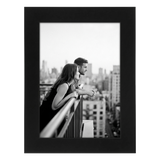 Black Signature frame, 5x7, no mat, holding a photo of a couple on a balcony above a city 