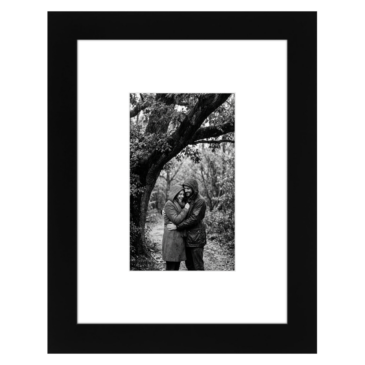 Black Signature frame, 6x8, with a wide white mat, holding a photo of a couple under a tree 