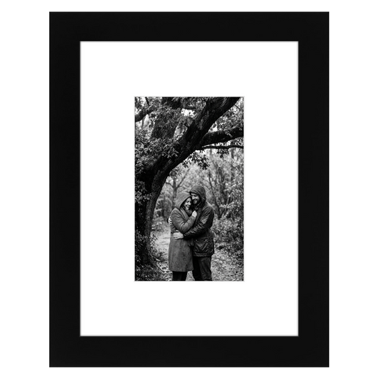 Black Signature frame, 6x8, with a wide white mat, holding a photo of a couple under a tree #flat