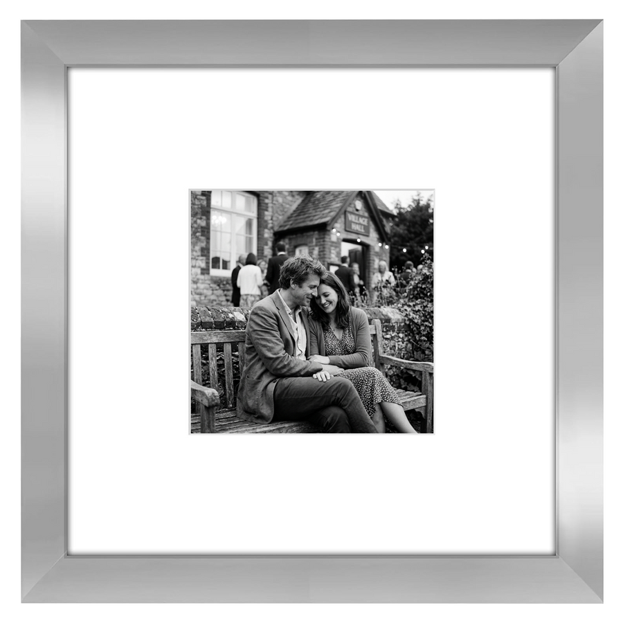Silver Signature frame, 8x8, with a wide white mat, holding a photo of a couple on a bench 