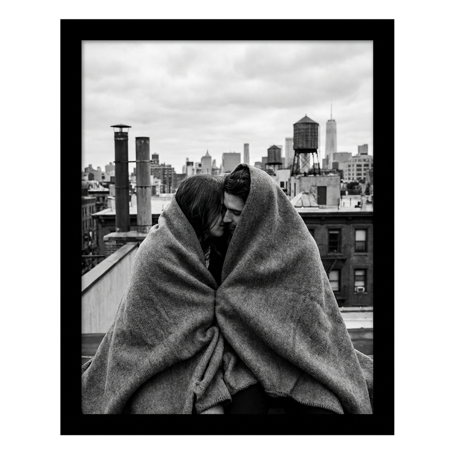 Black Signature frame, 10x12, no mat, holding a photo of a couple in a blanket above a city 