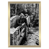 Oak Signature frame, 13x19, no mat, holding a photo of a couple with a dog on a picnic rug 