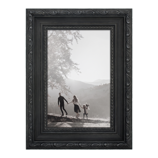 Ornate black 4x6 Heirloom frame with carved scrollwork, holding a family photo on a hillside #flat