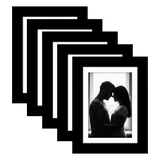 Five stacked black Galleria frames with white mats, holding a photo of a couple at a bright window 