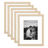 Five stacked natural oak Galleria frames with white mats, holding a photo of a couple under lights 