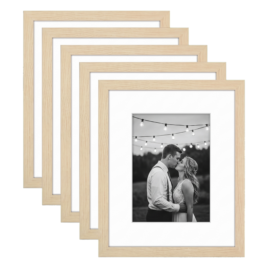 Five stacked natural oak Galleria frames with white mats, holding a photo of a couple under lights 