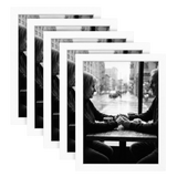 Five stacked white 8x11 Galleria frames, the front one holding a couple holding hands at a cafe window 