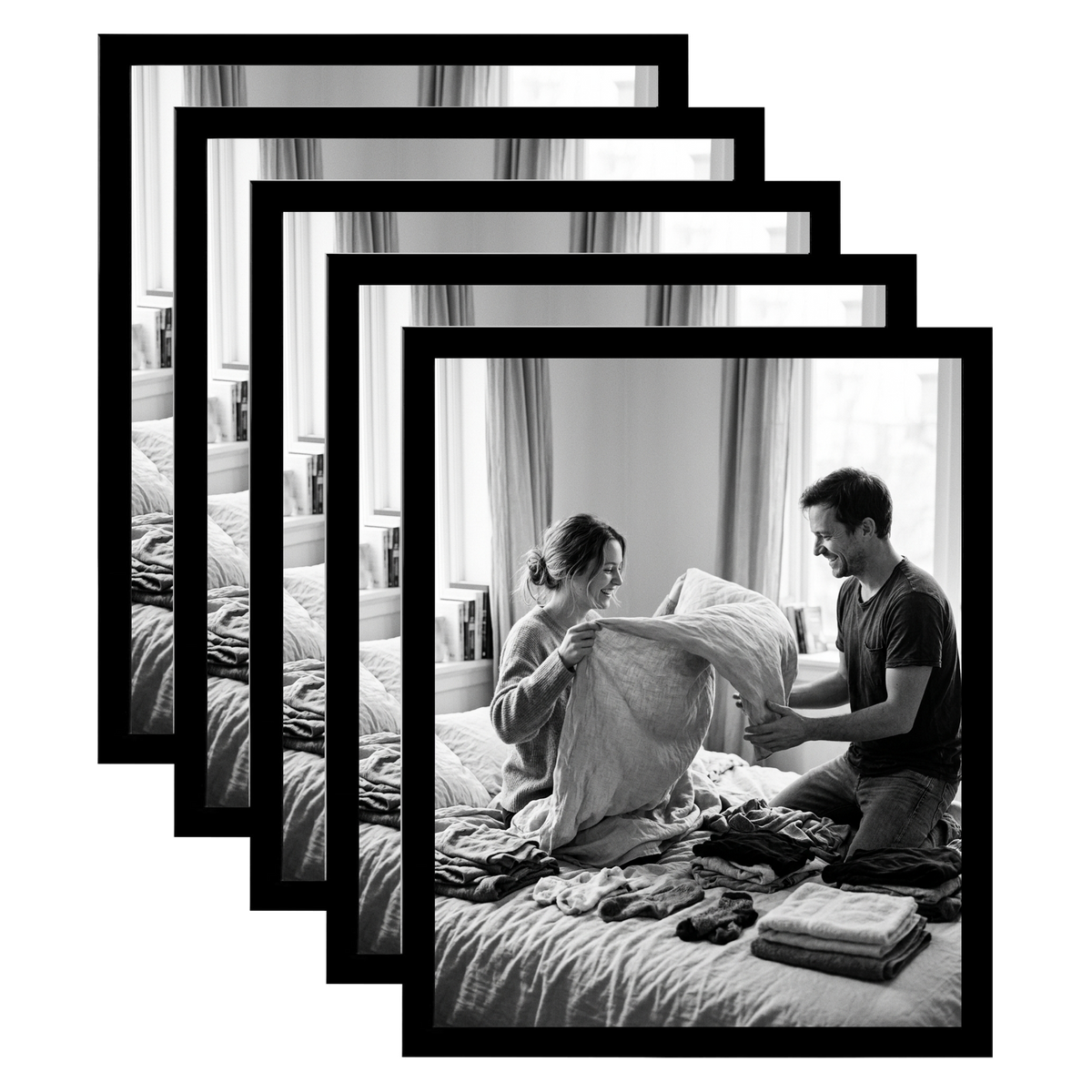 Five stacked black 11x14 Galleria frames, the front one holding a couple folding laundry on a bed 