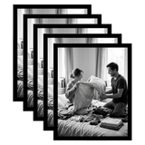 Five stacked black 11x14 Galleria frames, the front one holding a couple folding laundry on a bed 