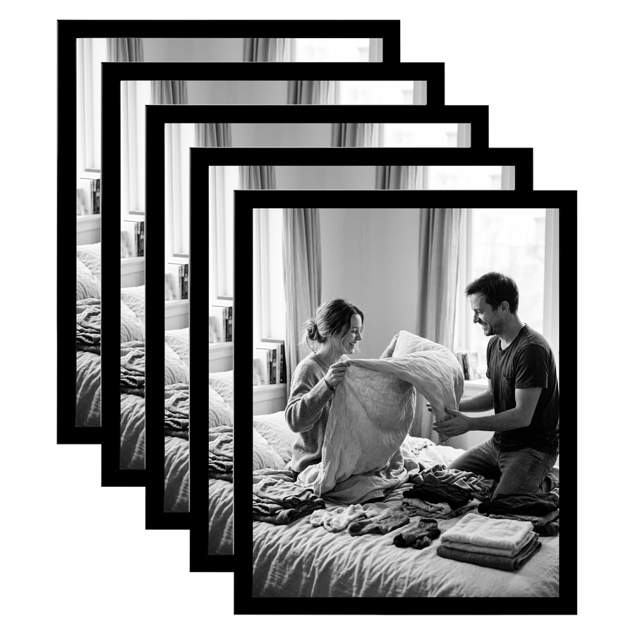 Five stacked black 11x14 Galleria frames, the front one holding a couple folding laundry on a bed 