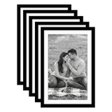 Five stacked black Galleria frames with white mats, holding a photo of a couple on a picnic rug 