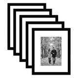 Five stacked black Galleria frames with white mats, holding a photo of a couple on an autumn avenue 