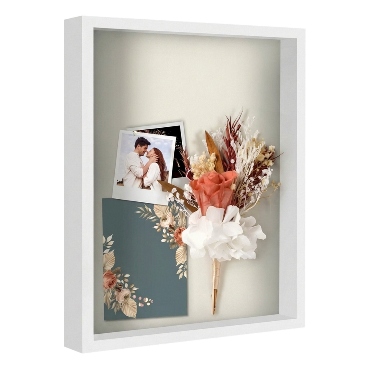 White 16x20 shadow box holding a wedding photo, dried flowers and an invitation 