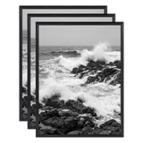 Three stacked black 11x14 Fusion frames all holding the same crashing wave photo 