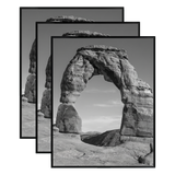 Three stacked black 22x28 Fusion frames all holding the same desert rock arch photo 