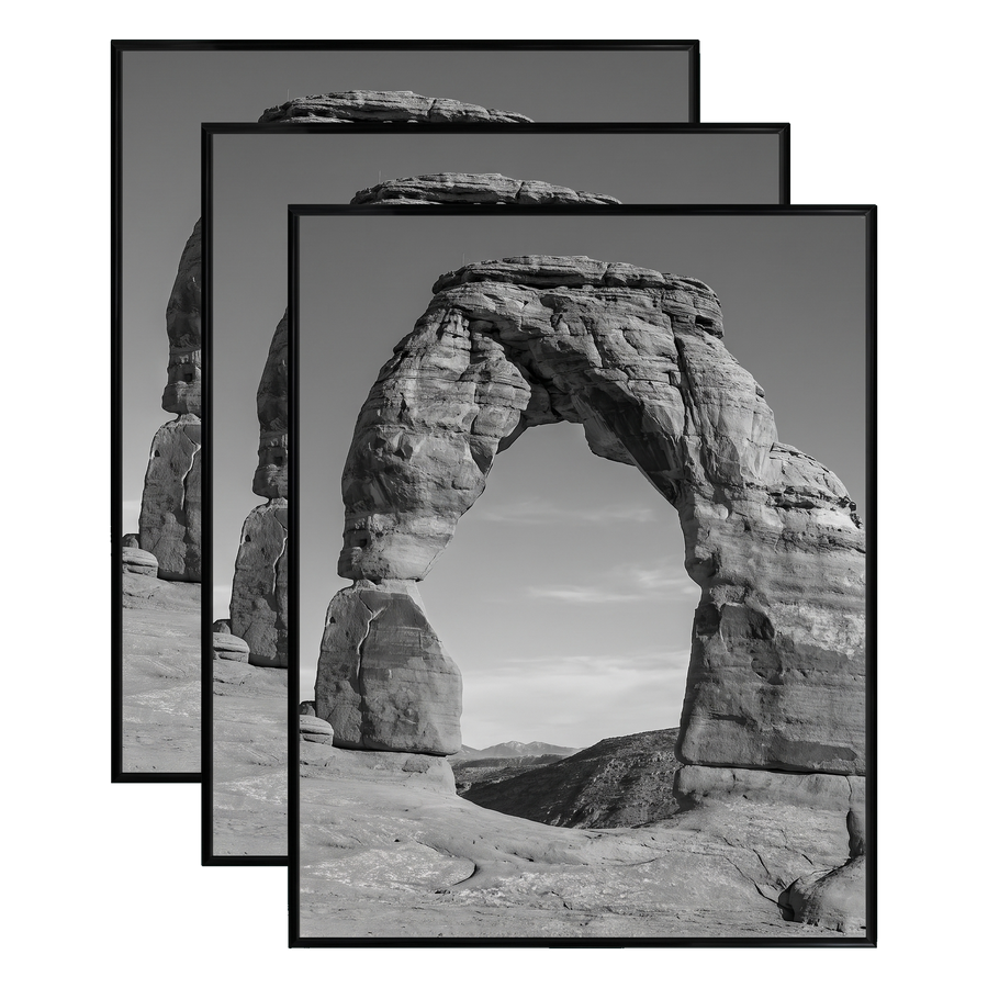 Three stacked black 22x28 Fusion frames all holding the same desert rock arch photo 