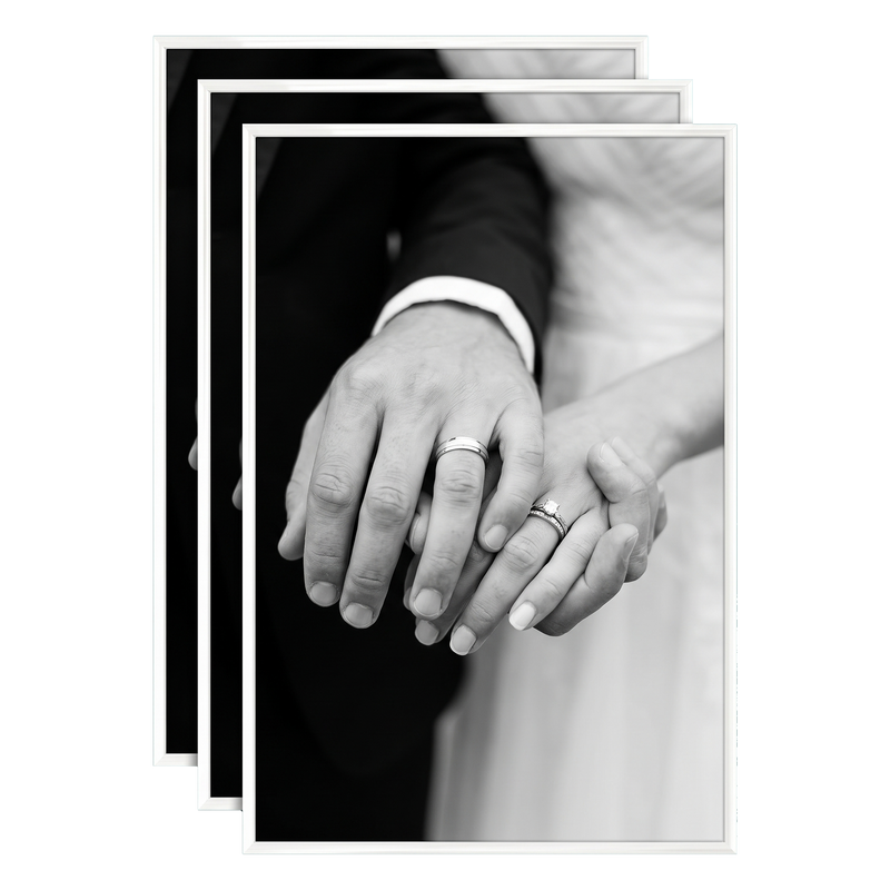 Three stacked white 16x24 Fusion frames all holding the same close-up of a bride and groom's hands #flat