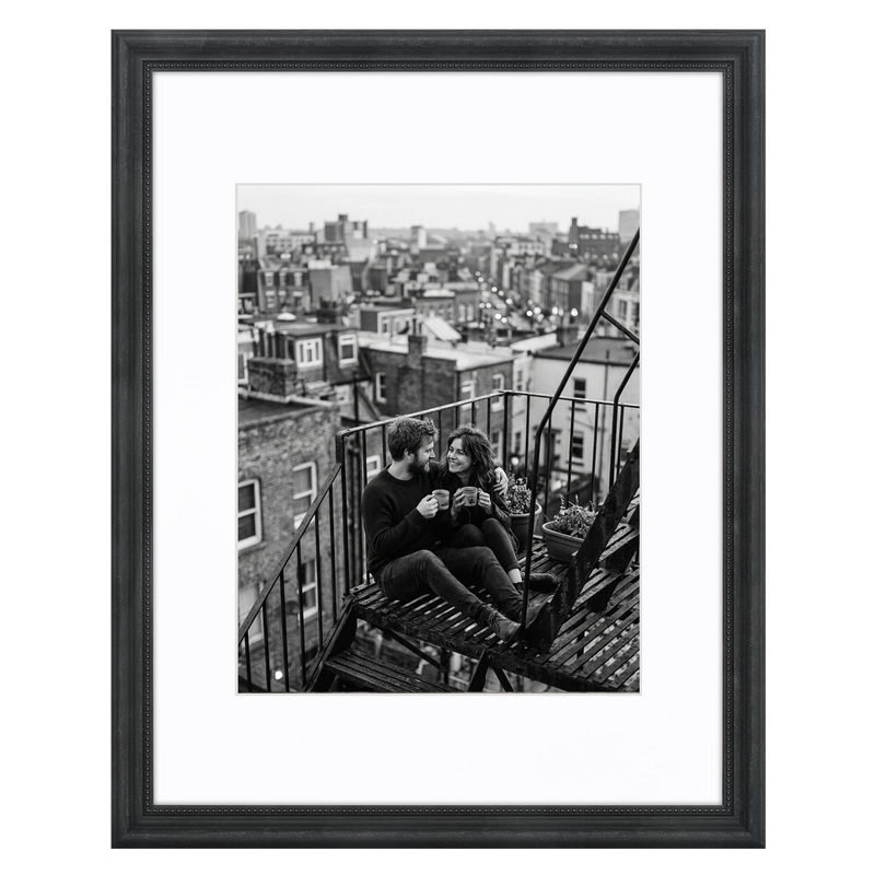 Black beaded Heirloom frame, 11x14, holding a black-and-white photo of a couple on a fire escape