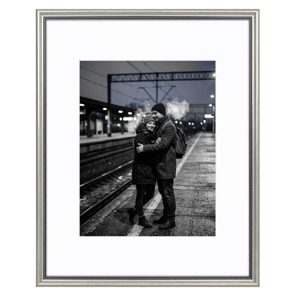 Silver beaded Heirloom frame, 16x20, holding a black-and-white photo of a couple embracing on a station platform
