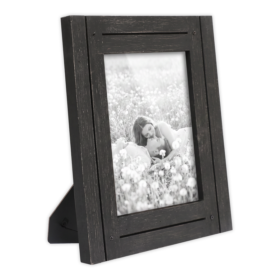 Angled black distressed 6x8 Hampton frame on its easel stand, a woman in a flower meadow 