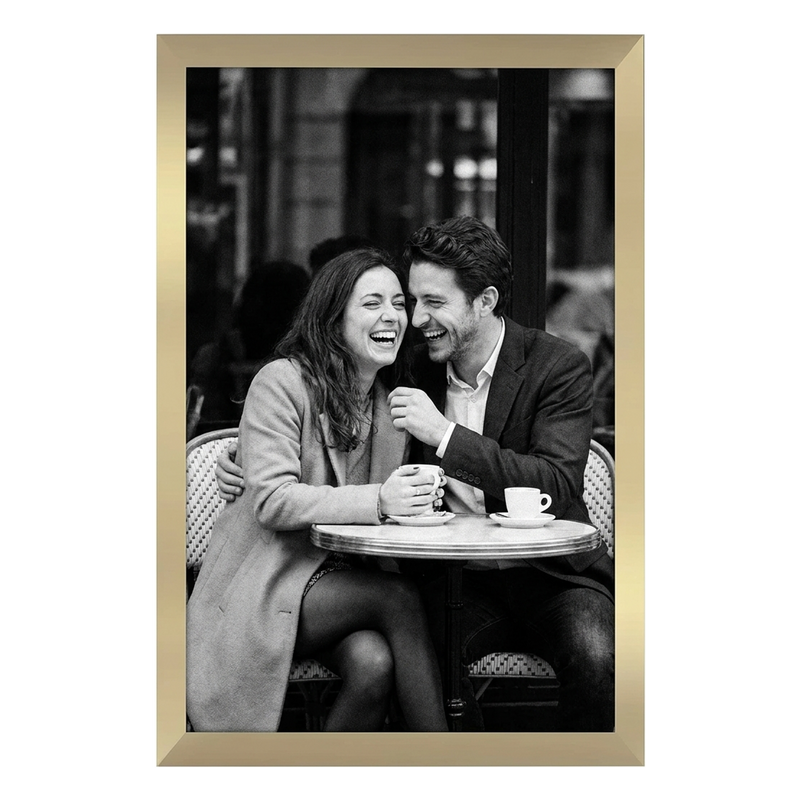 Gold Epic poster frame, 12x18, no mat, holding a black-and-white photo of a couple laughing at a cafe table #flat