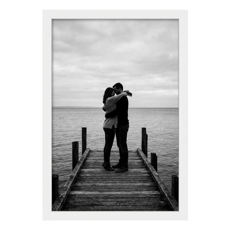 White Epic poster frame, 12x18, no mat, holding a black-and-white photo of a couple embracing on a jetty #flat