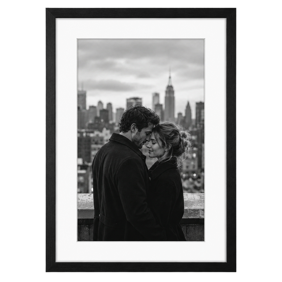 Black Epic frame, 14x20, with a white mat opening to 11x17, holding a photo of a couple against a city skyline 