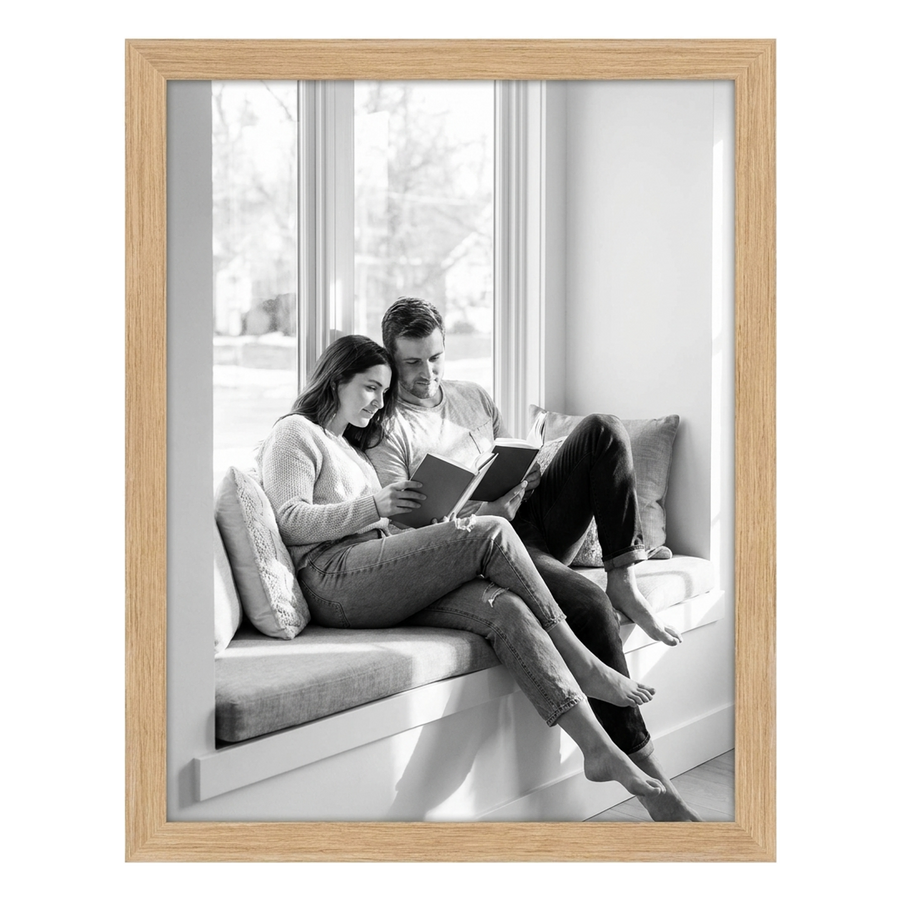 Natural oak Epic poster frame, 16x20, no mat, holding a black-and-white photo of a couple reading on a window seat 