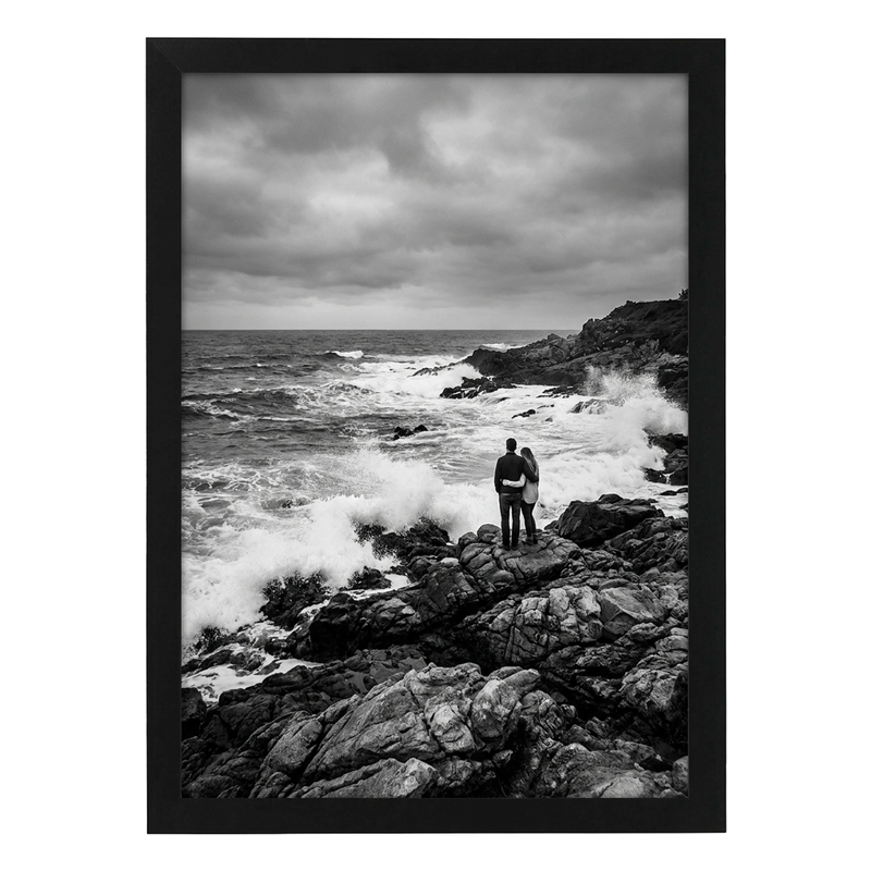 Black Epic poster frame, 19x27, no mat, holding a black-and-white photo of a couple on rocks by crashing surf #flat