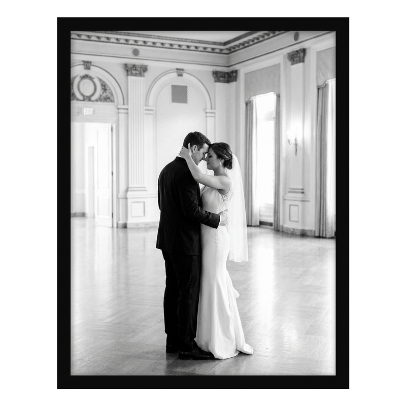 Black Epic poster frame, 24x30, no mat, holding a black-and-white photo of a bride and groom in a grand hall #flat
