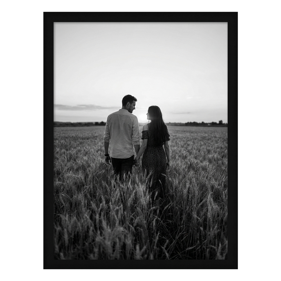 Black Epic poster frame, 24x32, no mat, holding a black-and-white photo of a couple in a wheat field at dusk 