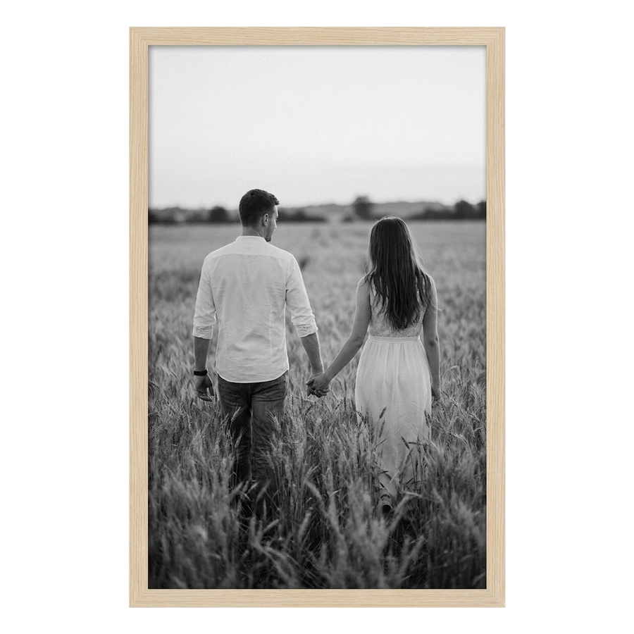 Pine Epic poster frame, 24x36, no mat, holding a black-and-white photo of a couple in a wheat field 