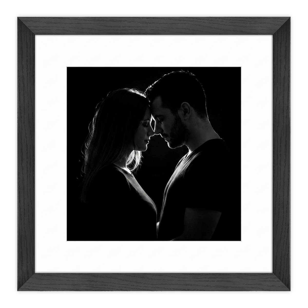 Black Hudson frame, 16x16, with a 12x12 white mat, holding a low-key black-and-white photo of a couple face to face 