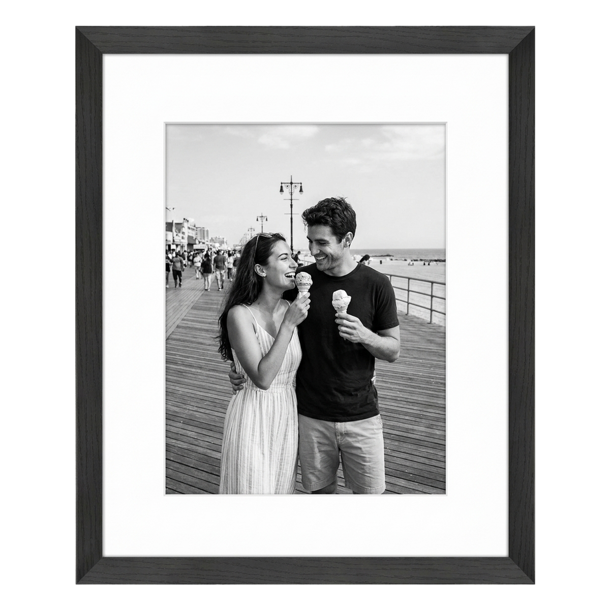 Black Hudson frame, 16x20, with an 11x14 white mat, holding a black-and-white photo of a couple eating ice cream on a pier 