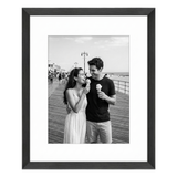 Black Hudson frame, 16x20, with an 11x14 white mat, holding a black-and-white photo of a couple eating ice cream on a pier 