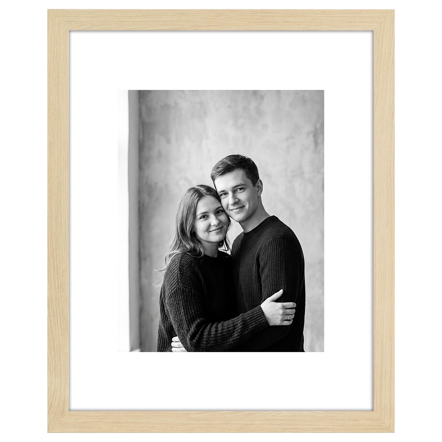 Natural oak Hudson frame, 16x20, with an 11x14 white mat, holding a black-and-white studio portrait of a couple 