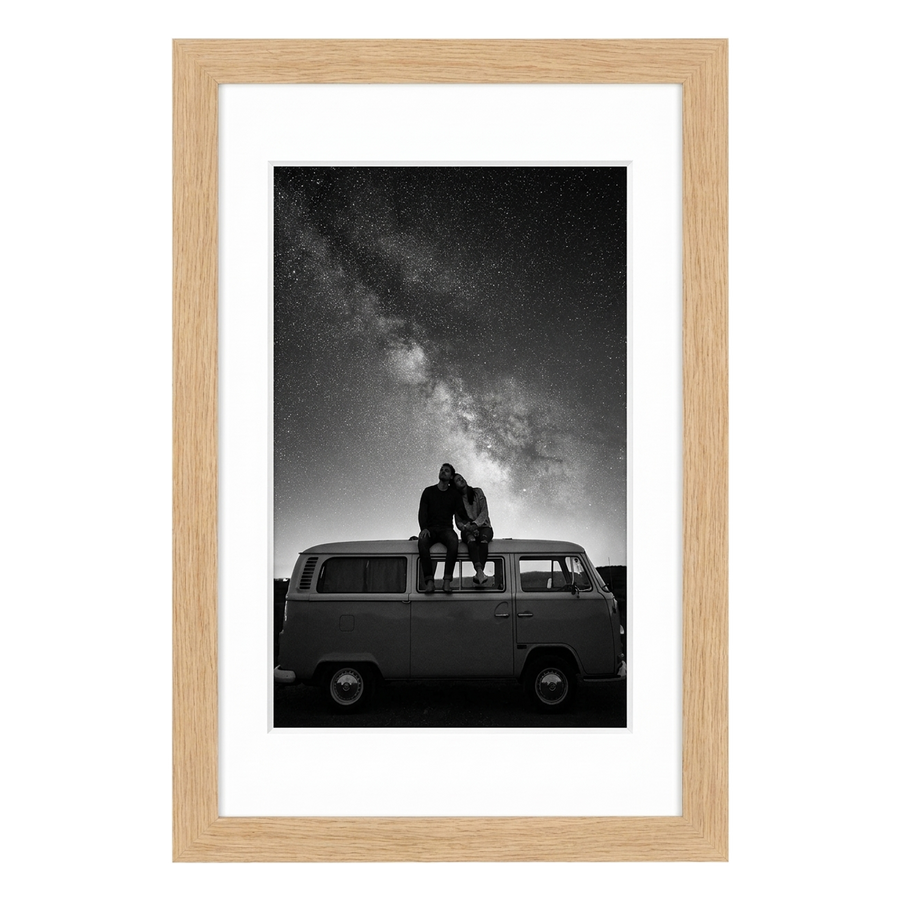 Natural oak Hudson frame, 16x24, with a 12x18 white mat, holding a black-and-white photo of a couple on a van beneath stars 