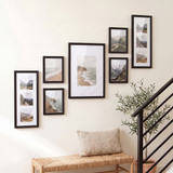 The ascending seven-frame set seen at an angle above a woven bench and olive tree