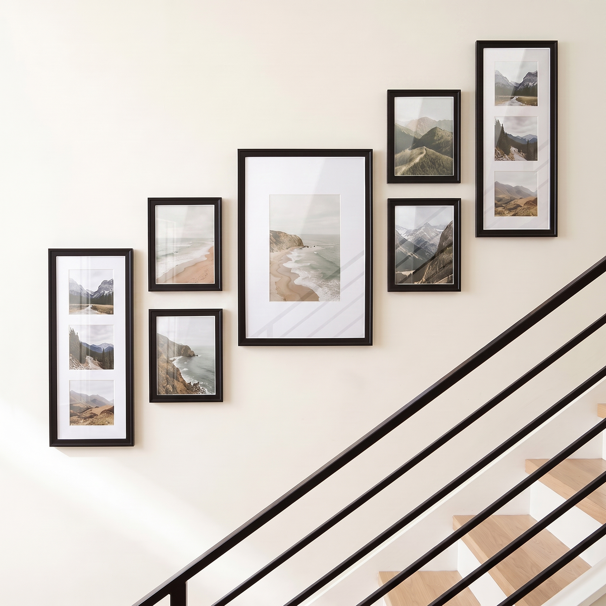 Ascending seven-frame black gallery wall with two three-opening collage frames and four unmatted 8x10s, all glazed