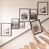 Hanging the last 8x10 to complete the balanced stairway gallery wall