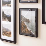Close detail of a three-opening collage frame beside an unmatted 8x10, both glazed